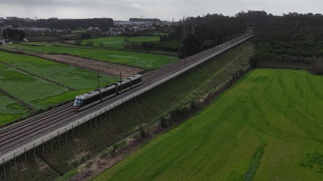 Eletrical subway riding in the middle of the farming fields. Sustainable public transportation