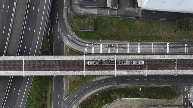 Eletrical subway riding on the tracks. Sustainable public transportation. Top down view.