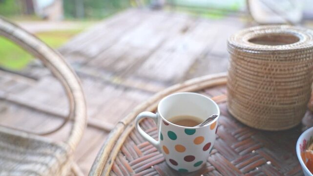 Close Up White Polka Dot Coffee Cup in Peaceful Morning at Sapan Nan Thailand
