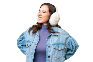 Young caucasian woman wearing winter muffs over isolated background suffering from backache for...