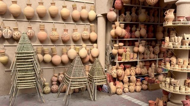 Pottery market in Nizwa, Oman, displaying traditional clay pottery and handcrafted items reflecting Omani heritage.