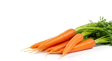 Fresh carrots with green tops on a white background ready for cooking or snacking