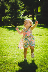 little girl is playing on the grass