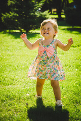 little girl is playing on the grass