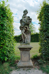 Obraz premium Luxury European Formal Garden with Symmetric Hedges and Classic Baroque Sculptures at Lysa nad Labem Castle Park, Czech Republic