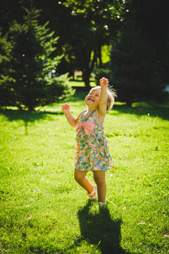 little girl is playing on the grass