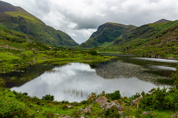 view down into the valley of Gap of Dunloe with the Auger Lake at a cloudy summer day in Kerry, Ireland