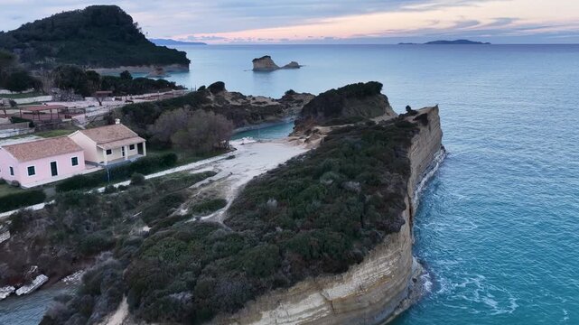 Cinematic aerial drone landscape of Canal d'Amour coastline at sunset with calm sea and distant islands, Sidari, Corfu, Greece, scenic romantic travel background