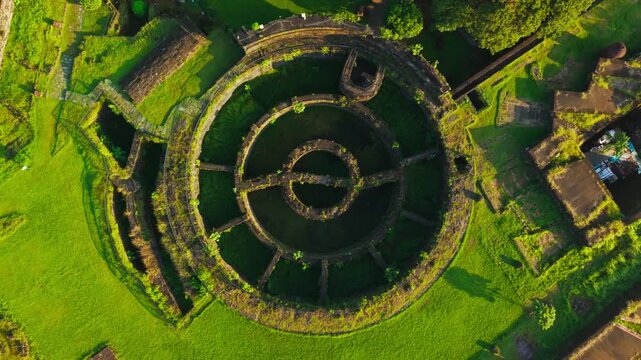 Cinematic aerial rotation over Baluarte de San Diego at sunrise in Manil