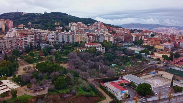 El Baix Guinard&oacute; neighborhood with Parc del Laberint d&rsquo;Horta and Tur&oacute; de la Rovira in Barcelona, Catalonia, Spain, drone slow push in and reveal