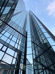 Glass skyscraper with reflections and modern architecture, symbolizing innovation and growth. © Yang Diao 