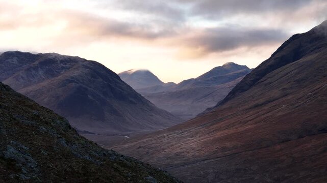 Stunning drone footage of Glencoe in the Scottish Highlands, showcasing Buachaille Etive Mor and Meall a'Bhuiridh mountains amid rugged valleys and misty, dramatic landscapes.