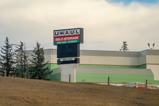 Calgary, Alberta, Canada. Feb 9, 2026. A large U-Haul Self-Storage pylon sign standing in front of a corporate warehouse facility.