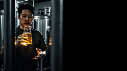 Professional brewer inspecting craft beer quality in a microbrewery