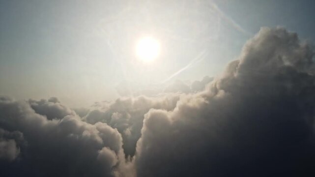 Aerial View Flying Through Clouds with Bright Sun