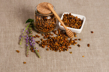 Bee bread grain on wooden background, close-up