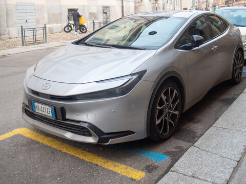 Toyota Prius XW60 hybrid car parked on urban street, showcasing modern design and sustainable transportation