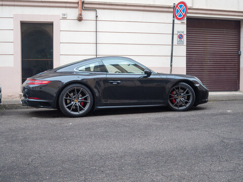 Porsche 911 Carrera 991 parked on an urban street, showcasing luxury sports car design and German engineering performance