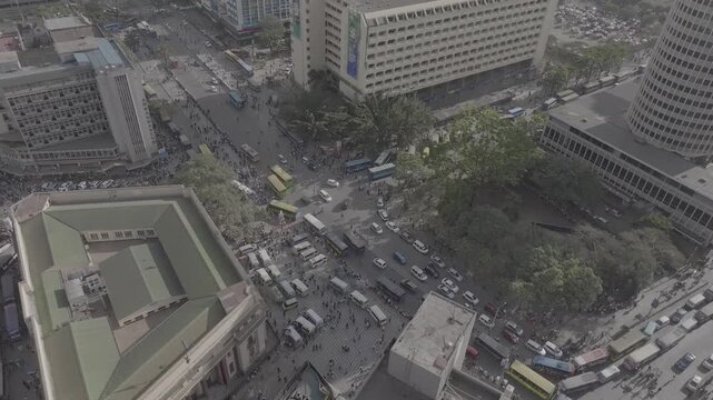 Aerial drone of view close up of Nairobi, Kenya featuring urban busy traffic, matatus, pedestrians, buses, archives building, Hilton hotel, Ambassador hotel, KCB building and other infrastructure