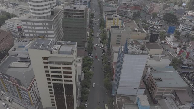 Drone aerial of Moi avenue in Nairobi, Kenya featuring urban traffic, matatus, pedestrians, retail buildings, and downtown infrastructure. Useful for concepts such as transportation and economy,