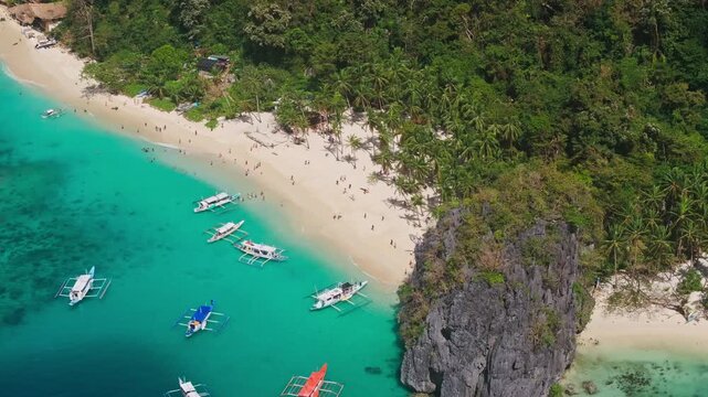 Island hopping, turquoise water boats, tourists, Seven Commandos Beach El Nido