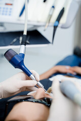 Fototapeta premium Dental cleaning using Air Flow technology to polish teeth and remove plaque.