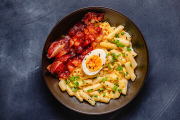 Korean street food - creamy rapokki served with bacon and egg.