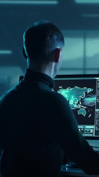 Soldier in a dimly lit military control room, intensely focused on multiple computer screens displaying crucial operational drone data.
