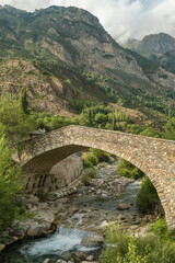 Title Ancient stone bridge over a mountain river in Huesca Pyrenees Spain