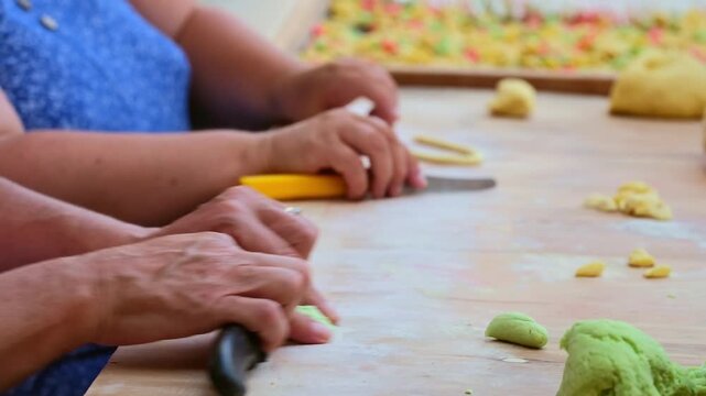 Detailed shot of hands making fresh Orecchiette pasta in Bari, Italy