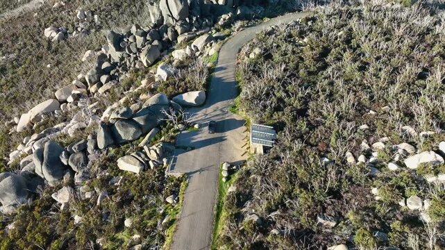 Adventure on Mt. Buffalo: Car Traveling Through Rugged Rocky Terrain