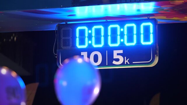 Marathon Race Digital Timer Showing 10K and 5K Distance at Night