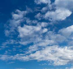 Fototapeta premium Beautiful clear blue sky with white fluffy clouds as a natural background