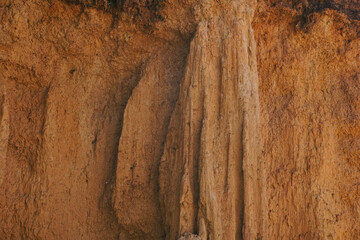 Naklejka premium Discover the raw beauty of ancient earth pillars and canyons, sculpted by centuries of natural erosion into a dramatic, sun-drenched landscape of rugged geological wonder.