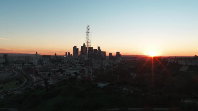 Close-up panning aerial shot of transmission tower in Elysian Park as the sun is setting in Los Angeles, California. 4K
