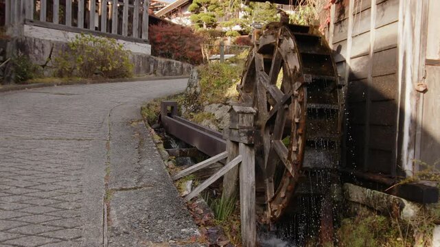 Famous old waterwheel in Tsumago Nakasendo town spins in slow motion
