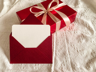 Red gift box and envelope with empty card on a white background