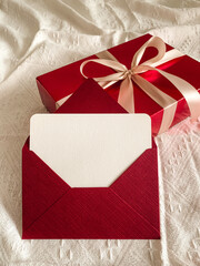 Red gift box and envelope with empty card on a white background