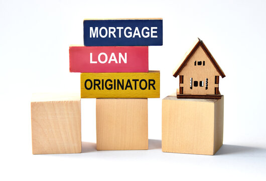 MORTGAGE LOAN ORIGINATOR - words on colored wooden blocks on a white background with a house