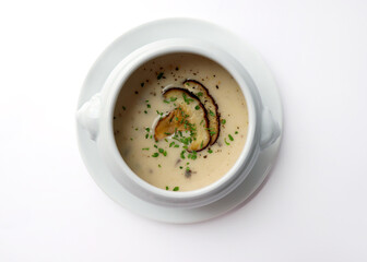 Warm mushroom soup in a bowl. White background.