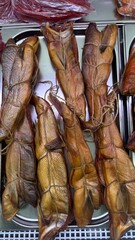 Hot smoked chum salmon belly displayed on metal tray in market  