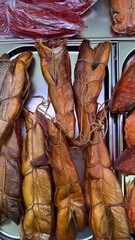 Hot smoked chum salmon belly displayed on fish market counter  