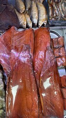 Cold smoked chum salmon fillet alongside various smoked fish products  
