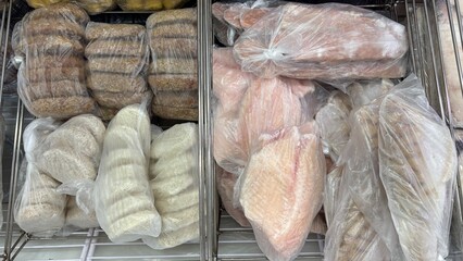 Packaged seafood products including tilapia, zander, and salmon fillet  