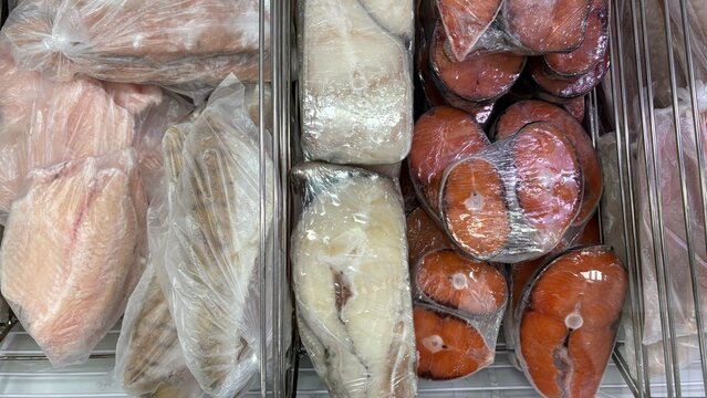 Fish market display with packaged fish and seafood products  