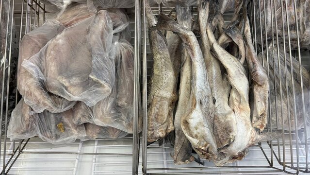 Dried fish displayed in wire racks at a fish market  