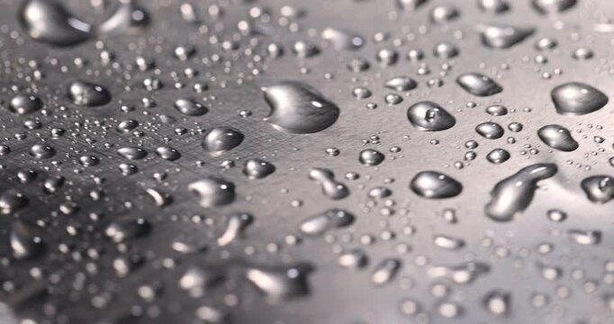 wet new foil with a lot of water on the surface, aluminum foil for food packaging coated with a large number of drops of clean water