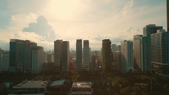 sunny sunset in Vietnamese coastal Da Nang city, My Khe sand beach and touristic My An and Son Tra district with modern skyscraper hotels and resorts, blue sea of Danang, Vietnam, aerial drone view 4k