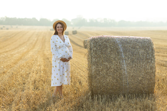 A pregnant woman outdoors. The concept of healthy pregnancy, prenatal care, pregnancy monitoring, and caring for the health of the expectant mother and child. Suitable for perinatal and medical clinic
