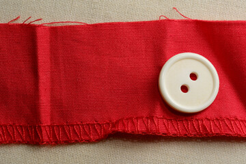 Red ribbon with a vintage white button displayed beautifully